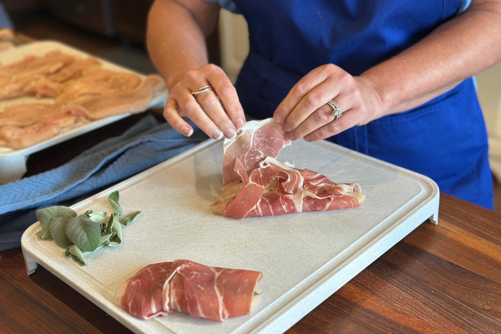 Wrap a slice of prosciutto around the chicken breast.
