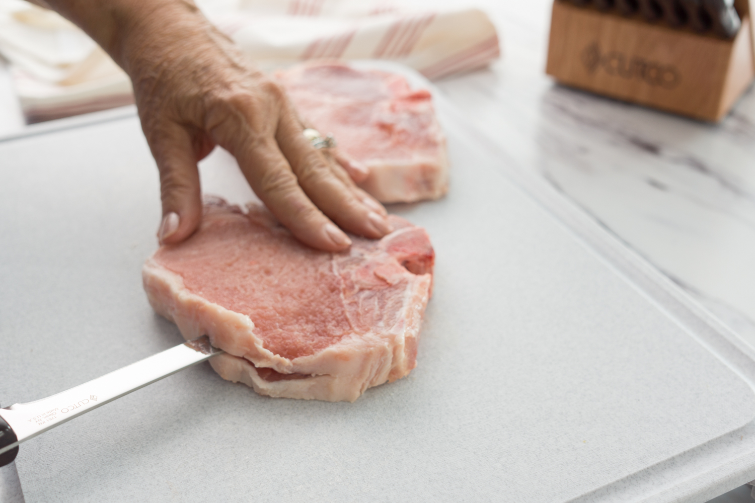 Slicing the pork chops with a Boning Knife.