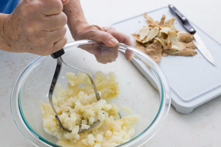 Mashing potatoes with a Masher.