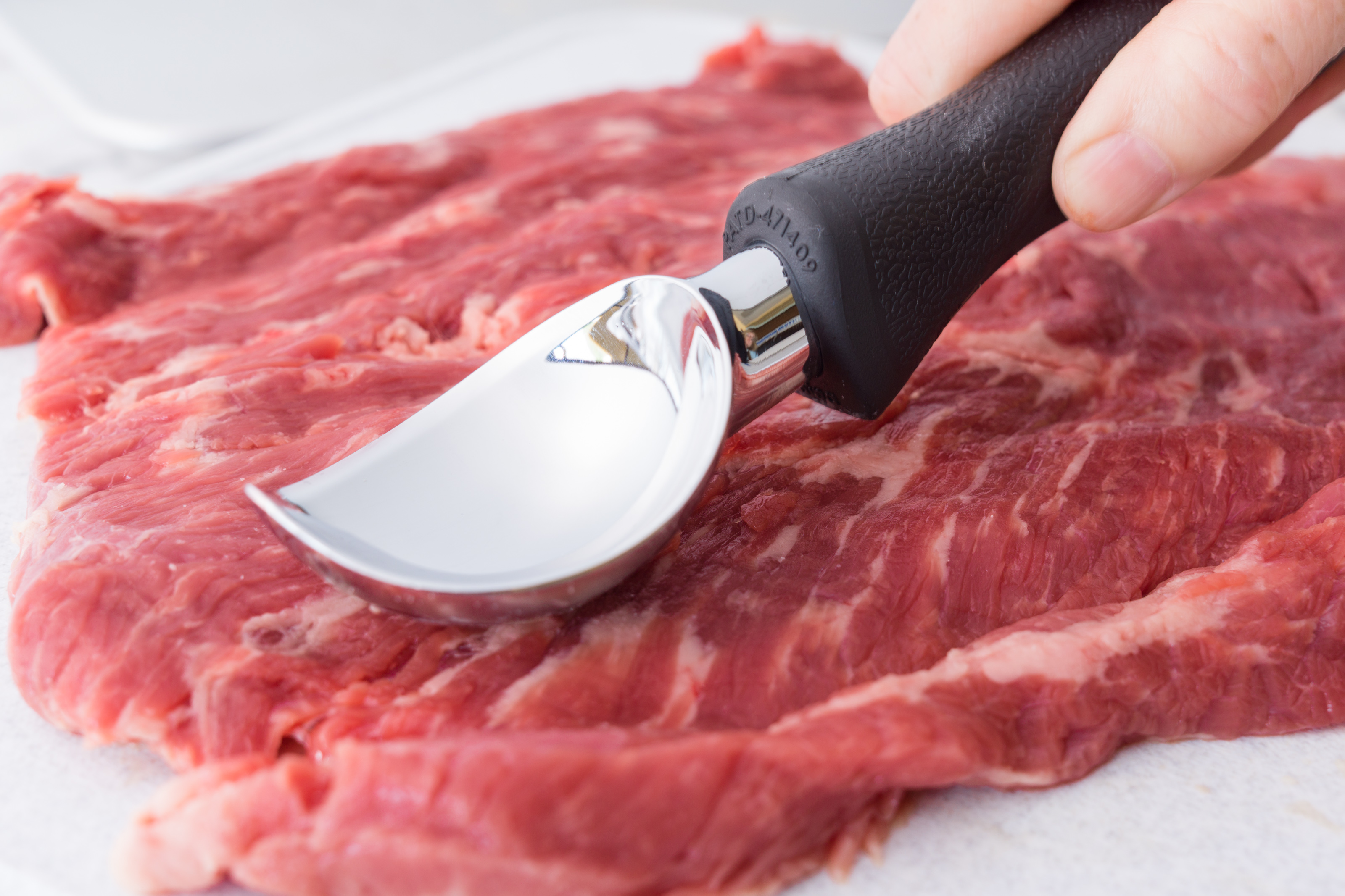 Using an Ice Cream Scoop to flatten the meat