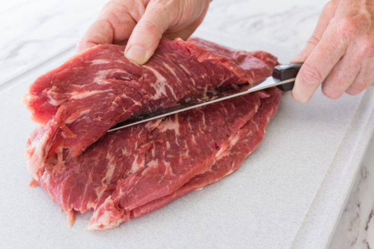 Using a Boning Knife to butterfly the flank steak.