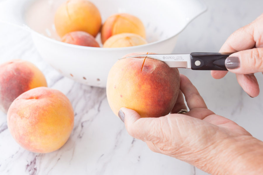 Cut an x in the top of each peach with a Paring Knife.