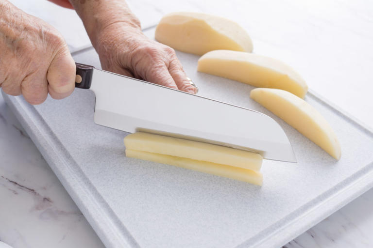 Cutting potatoes with a Santoku.