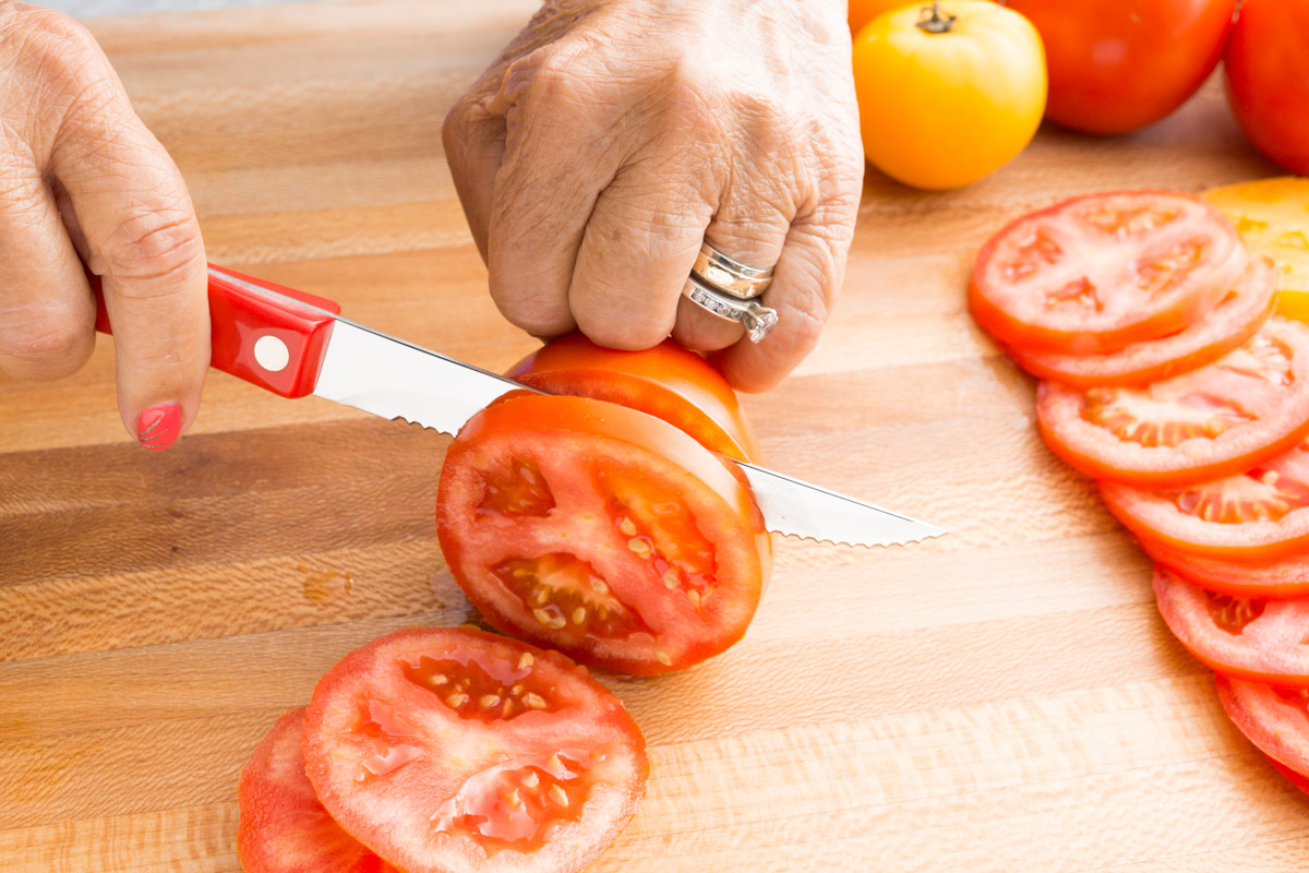 Slicing the tomatoes with a trimmer.